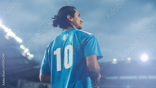 Football Match Championship  Portrait of Blue Team Soccer Player Holding a Ball  Standing  Smiling. Professional Hispanic Footballer  Future Champion Ready to Win Cup  Tournament. Medium Shot