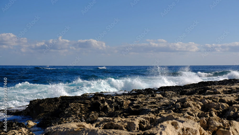 Blue sea wave and white foam and splash. Stone beach on island of Malta, no sandy beach. Summer holiday border frame concept. Tropical island vacation backdrop. Tourist travel banner design template. Blue sea wave and white foam and splash. Stone beach on island of Malta, no sandy beach. Summer holiday border frame concept. Tropical island vacation backdrop. Tourist travel banner design template.