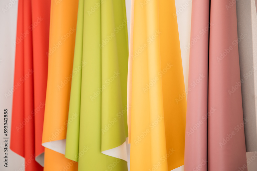 Faux leather of various colors displayed on a wall, leather factory Faux leather of various colors displayed on a wall, leather factory