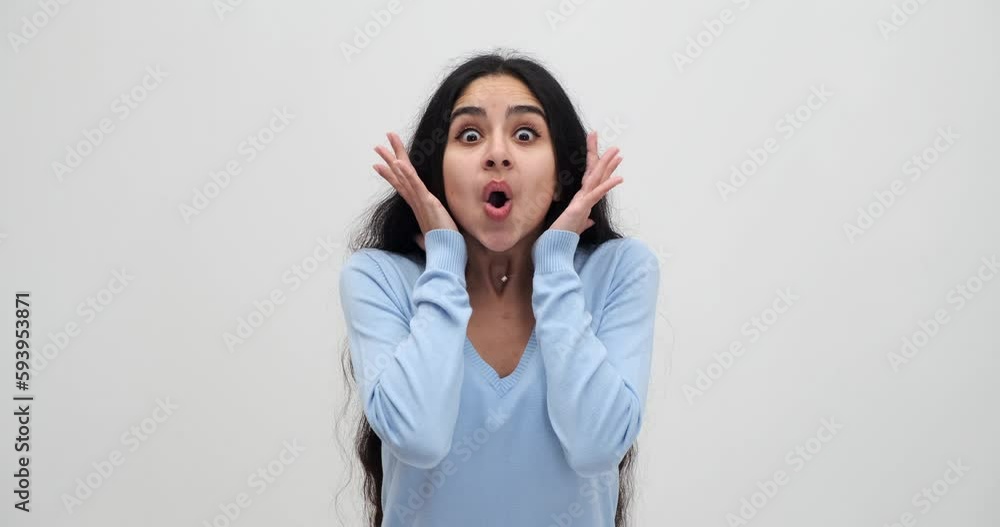 Astonished young woman celebrating and clapping hands in excitement Astonished young woman celebrating and clapping hands in excitement