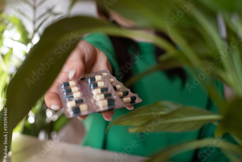 a girl sits and holds in her hands a lot of pills close-up with medicines in her hands, The concept of health care, Many drugs, chlorophyll in tablets, vitamins in tablets, healthy lifestyle