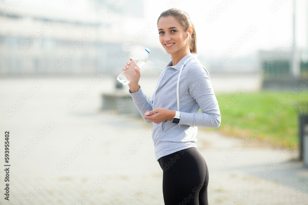 Portrait of fit young lady holding water bottle. Portrait of fit young lady holding water bottle.