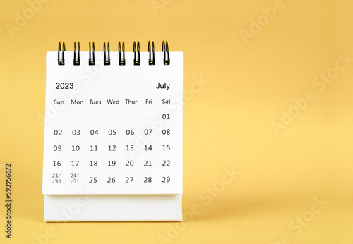 The July 2023 desk calendar on yellow color background.