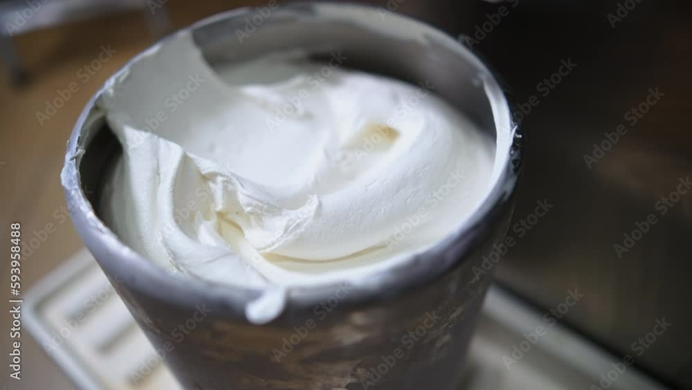 Freshly prepared vanilla ice cream in a steel container right from the freezer in a factory. High-quality 4k footage Freshly prepared vanilla ice cream in a steel container right from the freezer in a factory. High-quality 4k footage