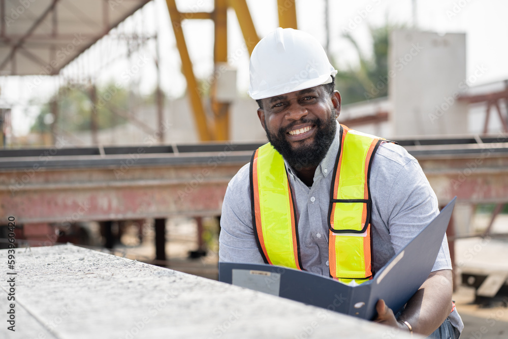 African American engineer man working with document at precast site work African American engineer man working with document at precast site work