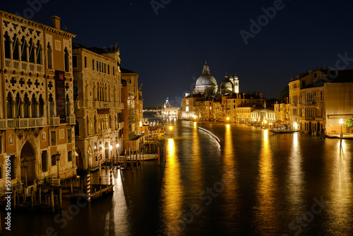 Venice, Italy: Night view of Venice Grand Canal with boats and Santa Maria della Salute church on sunset from Ponte dell'Accademia bridge. Venice, Italy © Matteo