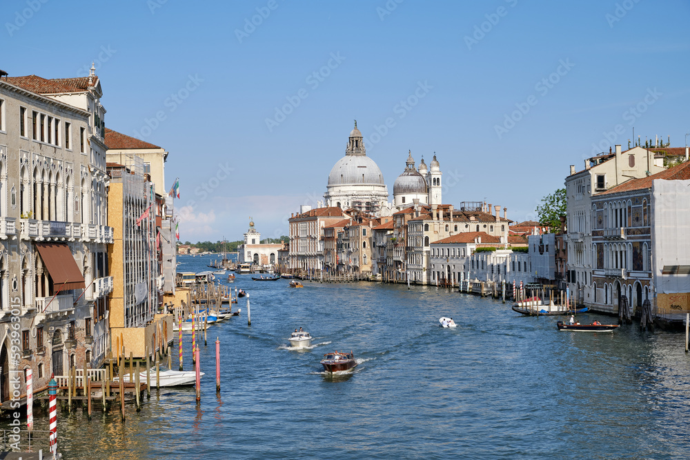 Venice, Italy: Panorama of Venice Grand Canal with boats and Santa Maria della Salute church on sunset from Ponte dell'Accademia bridge. Venice, Italy
