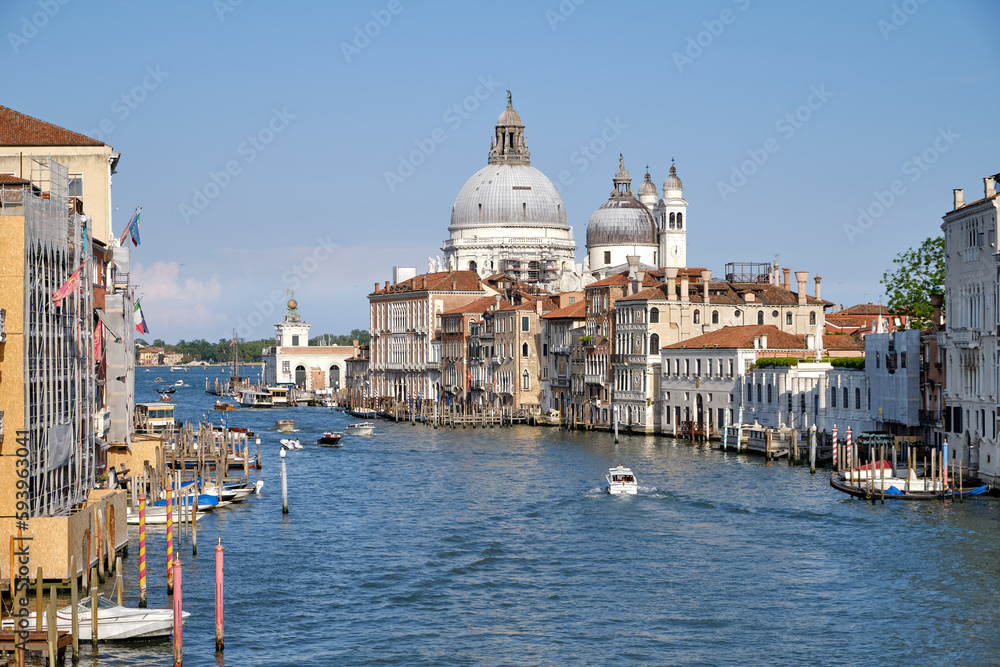 Venice, Italy: Panorama of Venice Grand Canal with boats and Santa Maria della Salute church on sunset from Ponte dell'Accademia bridge. Venice, Italy