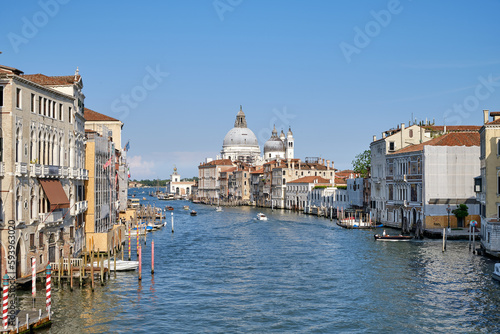 Venice, Italy: Panorama of Venice Grand Canal with boats and Santa Maria della Salute church on sunset from Ponte dell'Accademia bridge. Venice, Italy