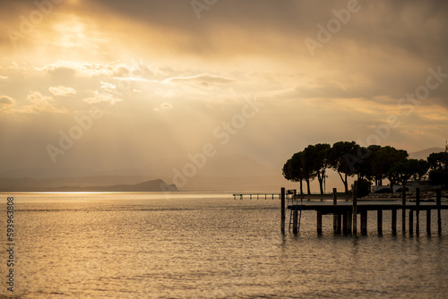 Golden sunset on the Italian Garda lake  beach