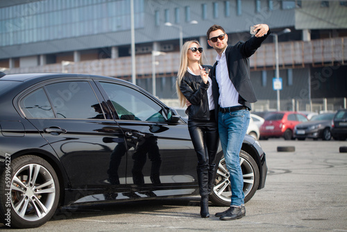 Happy young couple chooses and buying a new car for the family. © Maksymiv Iurii