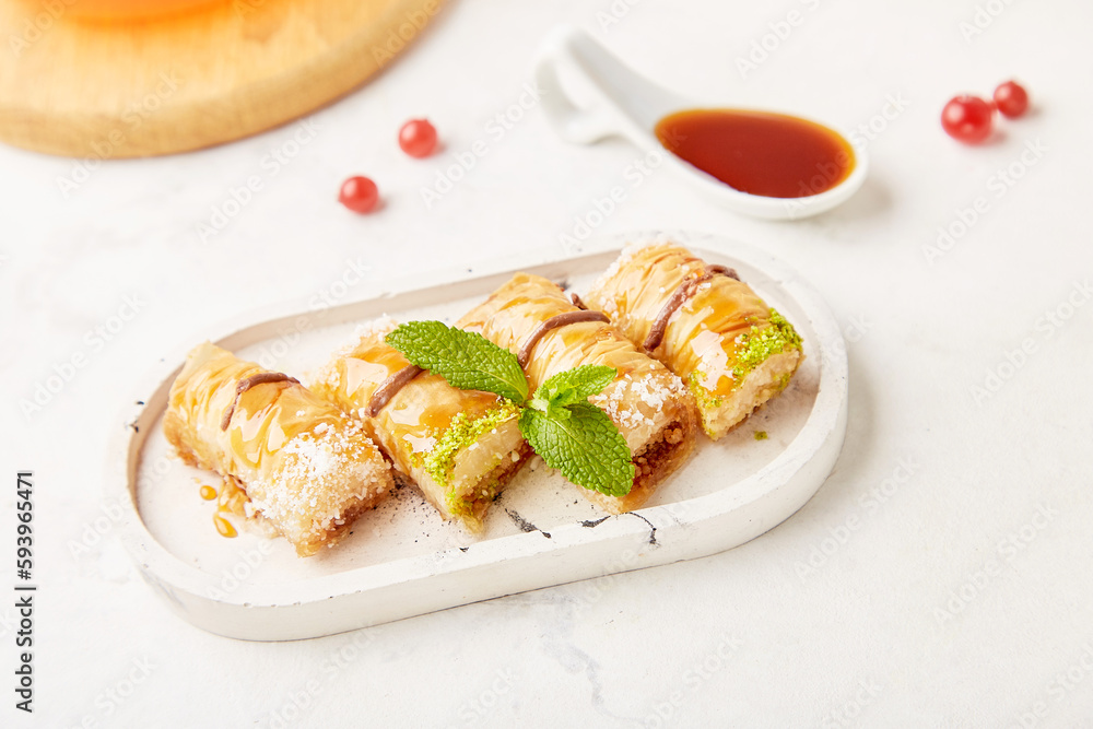 Baklava - traditional turkish dessert with honey and mint. Natural sweets close up Baklava - traditional turkish dessert with honey and mint. Natural sweets close up