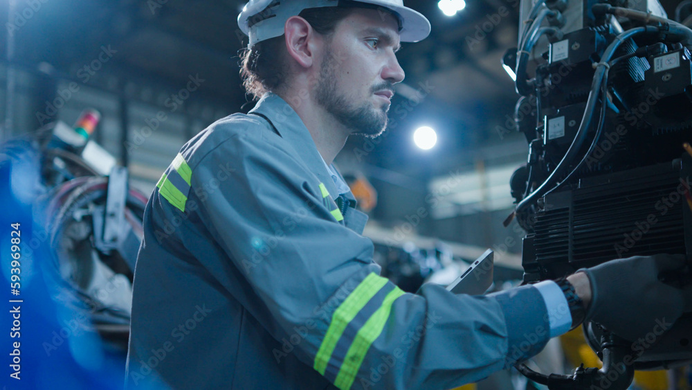 Professional industrial engineer, technician, factory worker wear hard hat safety. While set up, control machine heavy industry factory. Employee working in manufacturing facility Professional industrial engineer, technician, factory worker wear hard hat safety. While set up, control machine heavy industry factory. Employee working in manufacturing facility