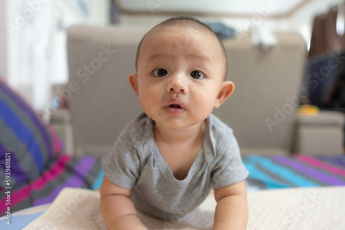Porttrait of Adorable, Asian newborn baby looking at camera. Little innocent new infant child in first day of life. Mother day concept.