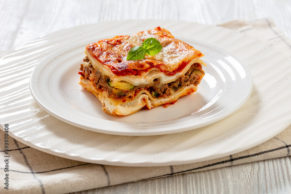portion of Lasagna on white plate, top view portion of Lasagna on white plate, top view