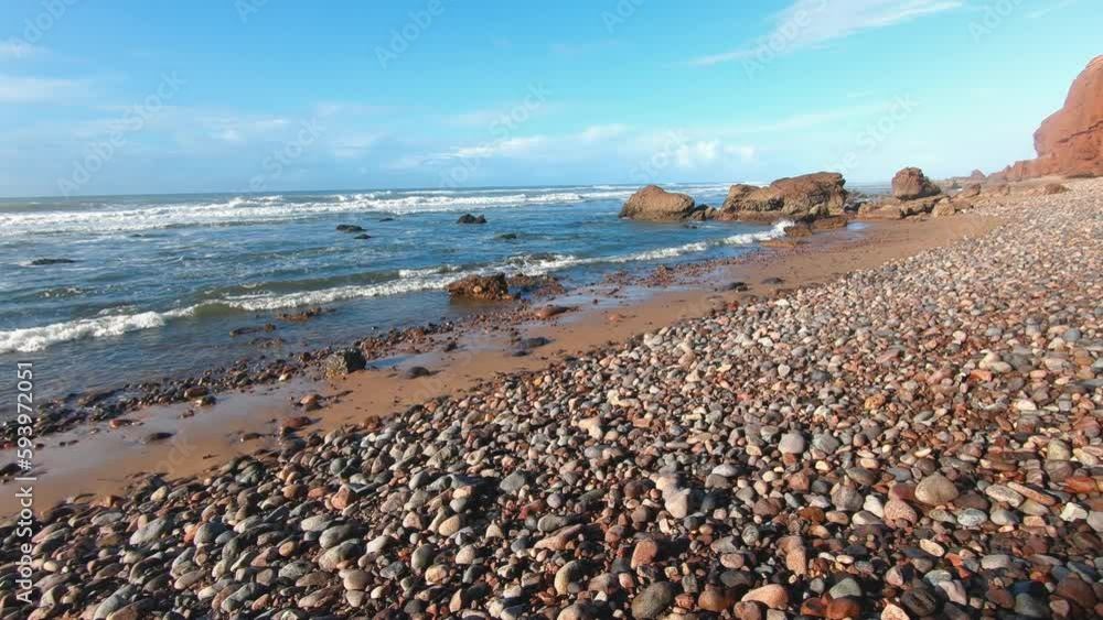 Rocky beach in Morocco ocean coast in beautiful summer holiday travel background, ideal for surf practice Rocky beach in Morocco ocean coast in beautiful summer holiday travel background, ideal for surf practice