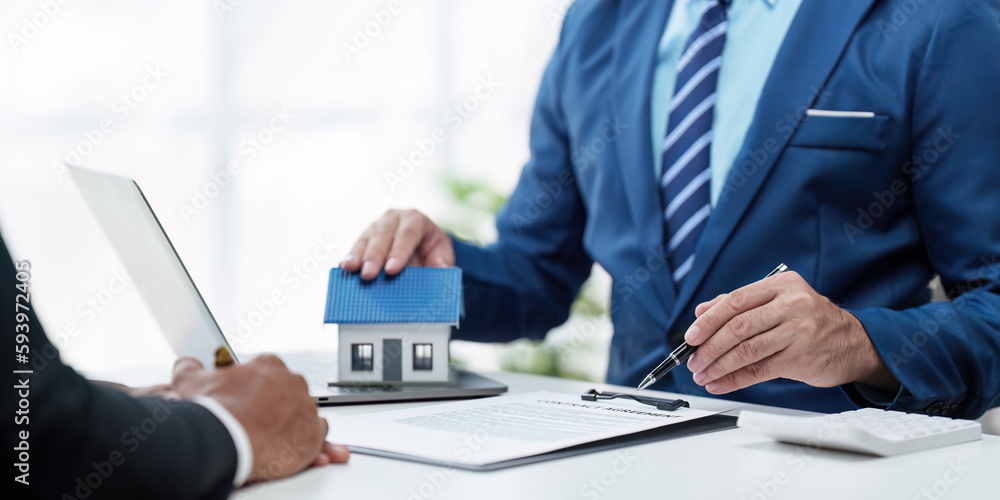 Close up Business people or Real Estate agent explain signing agreement for sale house to client. Property, Insurance, Broker concept Close up Business people or Real Estate agent explain signing agreement for sale house to client. Property, Insurance, Broker concept