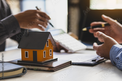 Real estate agent discuss about the terms of the home purchase agreement and asked the customer to sign the documents to make the contract legally, Home sales, lease, mortgage and home insurance.