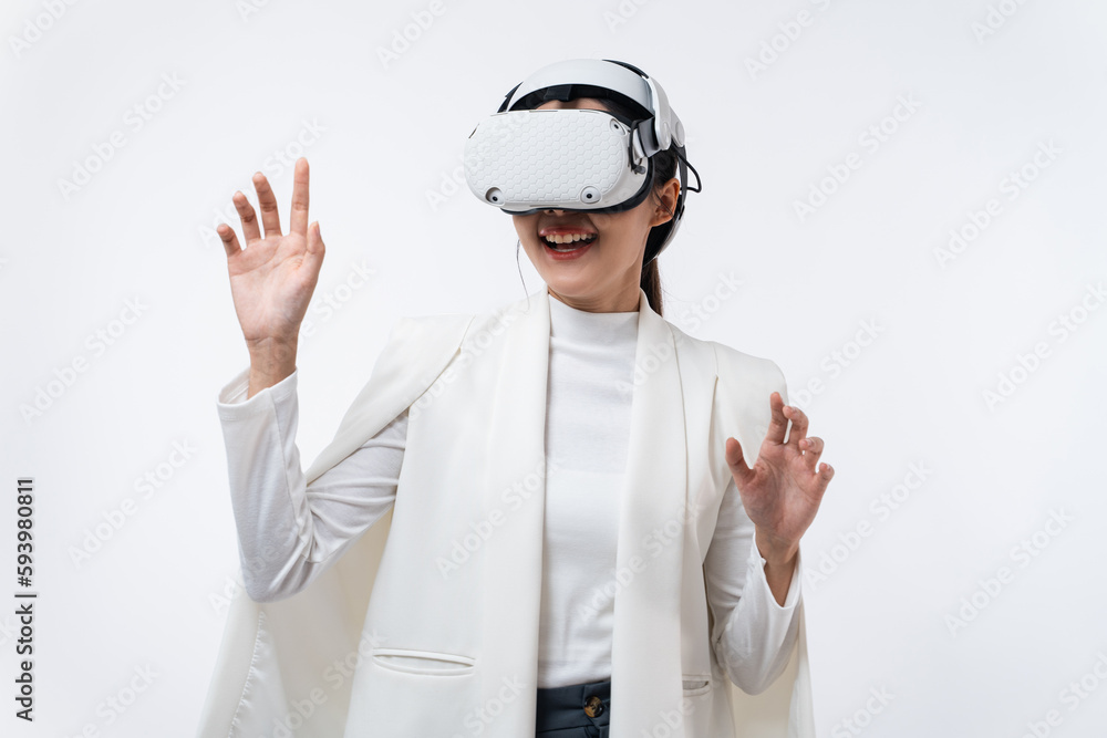 Happy young Asian businesswoman working in virtual reality environment in VR glasses touching virtual interface isolated on white background. Happy young Asian businesswoman working in virtual reality environment in VR glasses touching virtual interface isolated on white background.