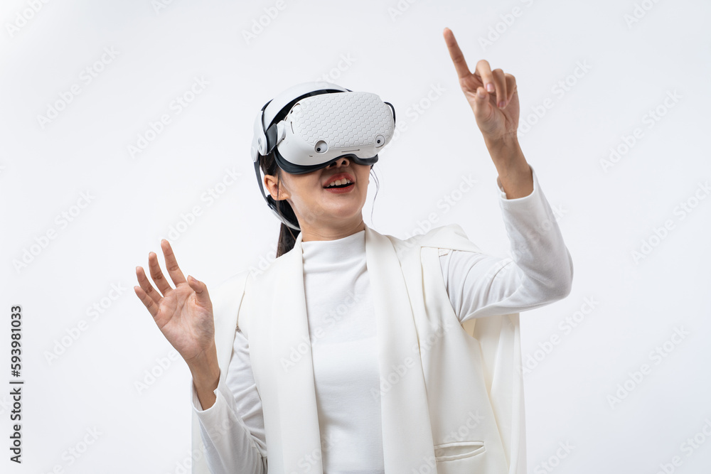 Happy young Asian businesswoman working in virtual reality environment in VR glasses touching virtual interface isolated on white background. Happy young Asian businesswoman working in virtual reality environment in VR glasses touching virtual interface isolated on white background.