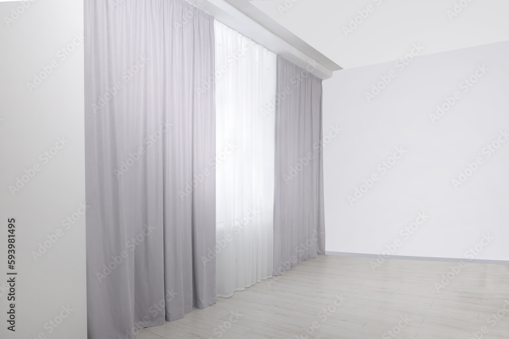 Fototapeta premium Light grey window curtains and white tulle indoors