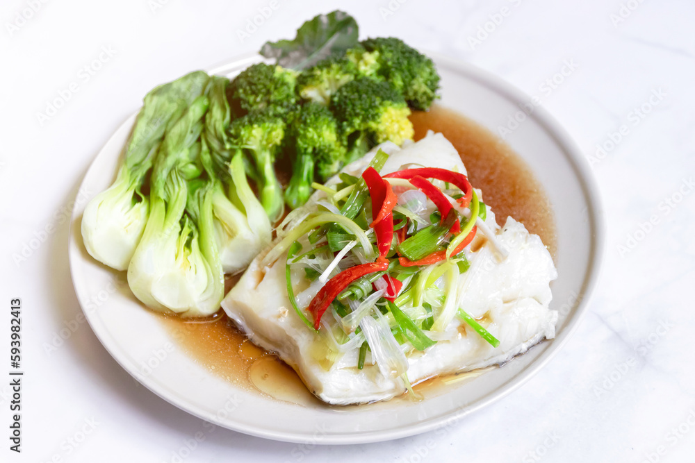 Steamed snow fish with soy sauce. Snow fish, soy sauce, ginger, scallion and chili delicious healthy menu on white table background. Steamed snow fish with soy sauce. Snow fish, soy sauce, ginger, scallion and chili delicious healthy menu on white table background.