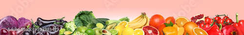 Many different fresh fruits and vegetables on pink background. Banner design