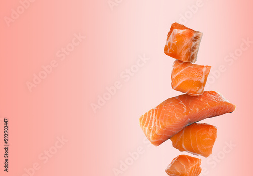 Cut fresh salmon falling on pink gradient background, space for text photo