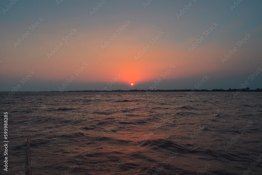 Fototapeta premium Beautiful view of sunset during boat journey through Bhitarkanika National Park, Odissa, India