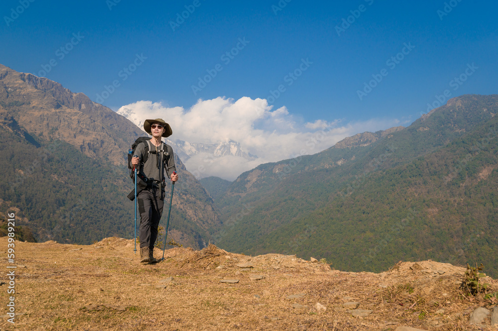 A young traveller trekking on forest trail , Nepal