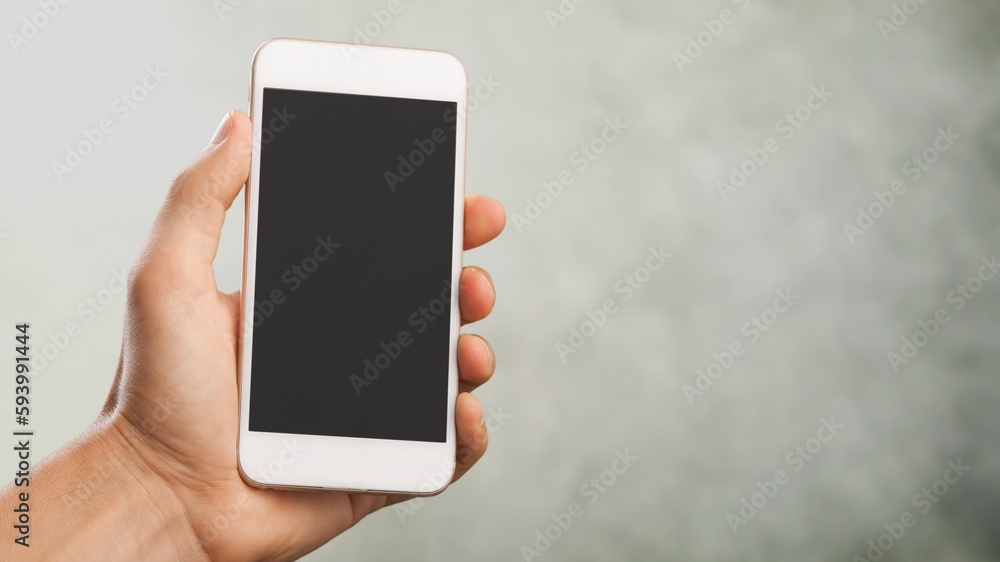 Hand holding phone with a blank screen Hand holding phone with a blank screen