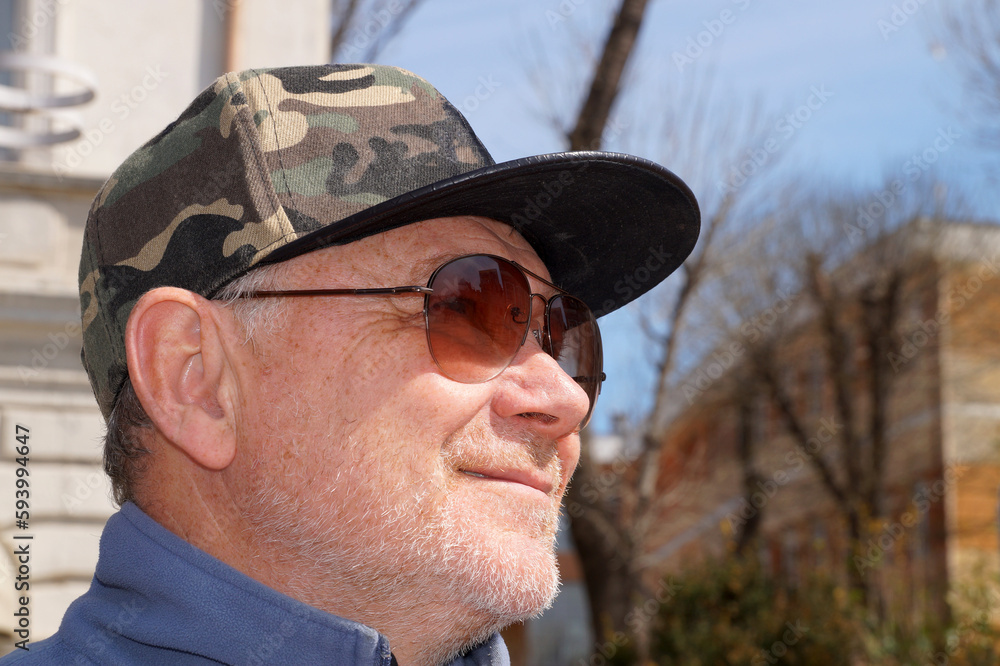 smiling man in cap and sunglasses close up smiling man in cap and sunglasses close up