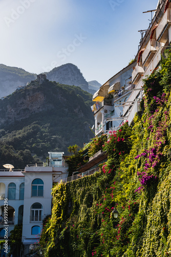 View of the flowering side of a house in Amalfi with mountains in the background