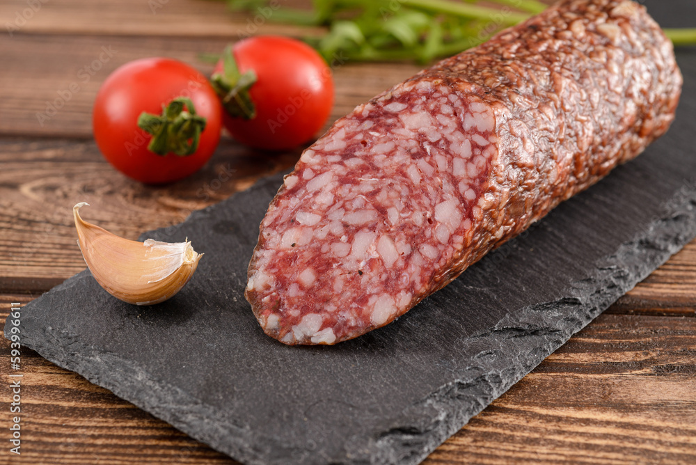 Salami sausage cut with tomato and garlic Salami sausage cut with tomato and garlic