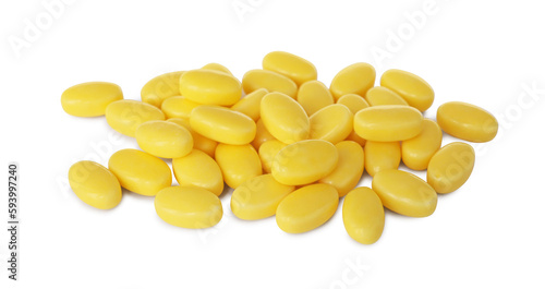 Tasty yellow dragee candies on white background