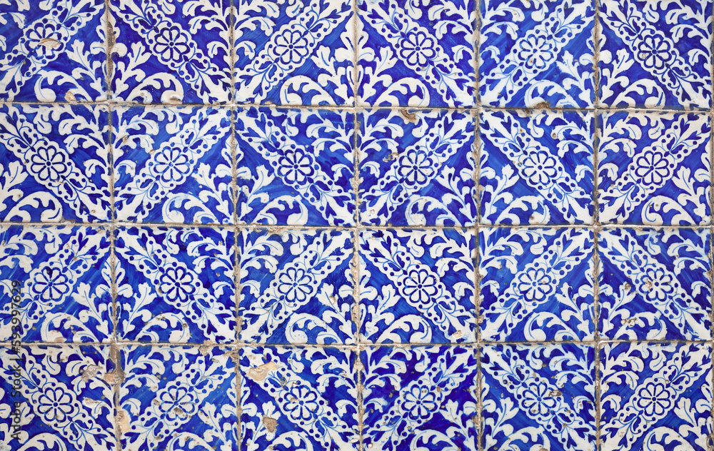 Azulejos tiles with cracks. Traditional Portuguese mosaic, blue and white