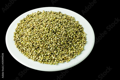 organic dried hemp seeds on a white plate