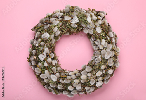 Wreath made of beautiful willow flowers on pink background, top view