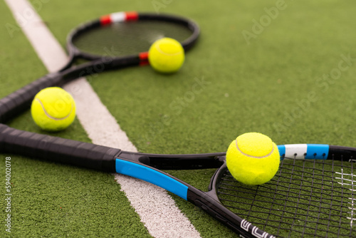 tennis racket with balls on green background. © Angelov