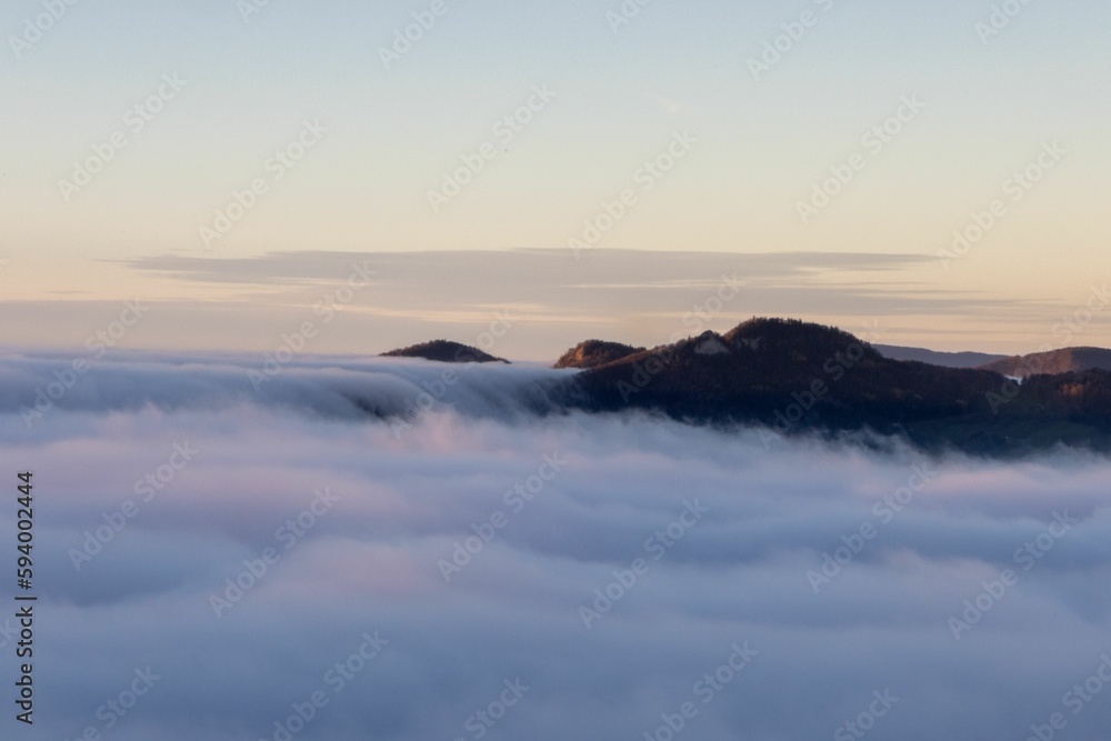 A mountain top peeking through a white fluffy cloud, Solothurn, Wisen municipality of Switzerland