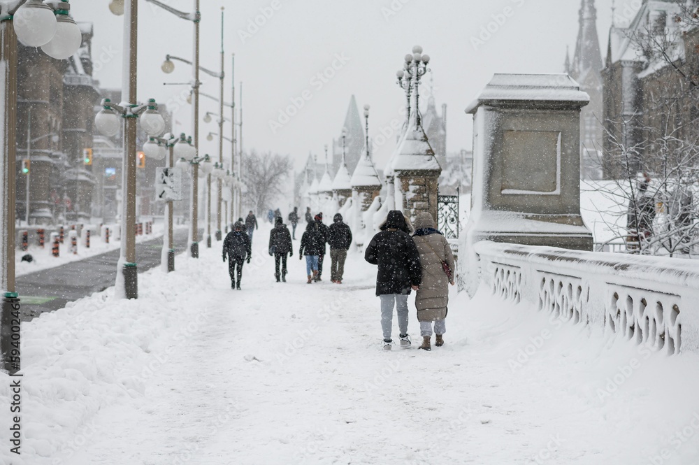 Fototapeta premium People walking outdoors during a cold snowy day in Ottawa, Canada