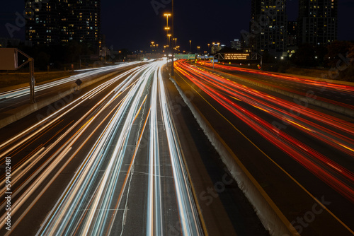 Speed traffic, light trails on freeway at night, long exposure abstract urban background. Toronto West highway 427 southbound. High travel speed effect, dui, careless, dangerous, drunk driving concept
