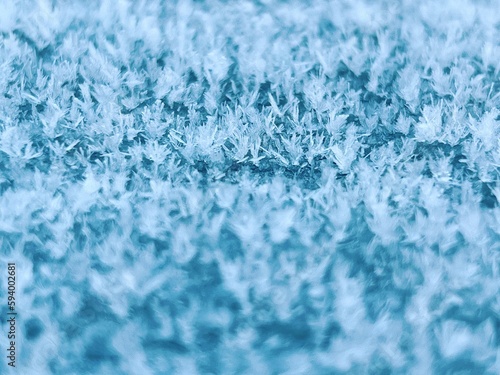 Close-up shot of a cold, frosty surface exhibiting a crystalline coating of frost particles photo