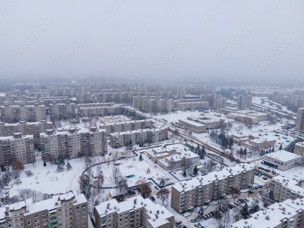 Aerial shot of soviet apartment houses covered with snow in Kaunas Lithuania