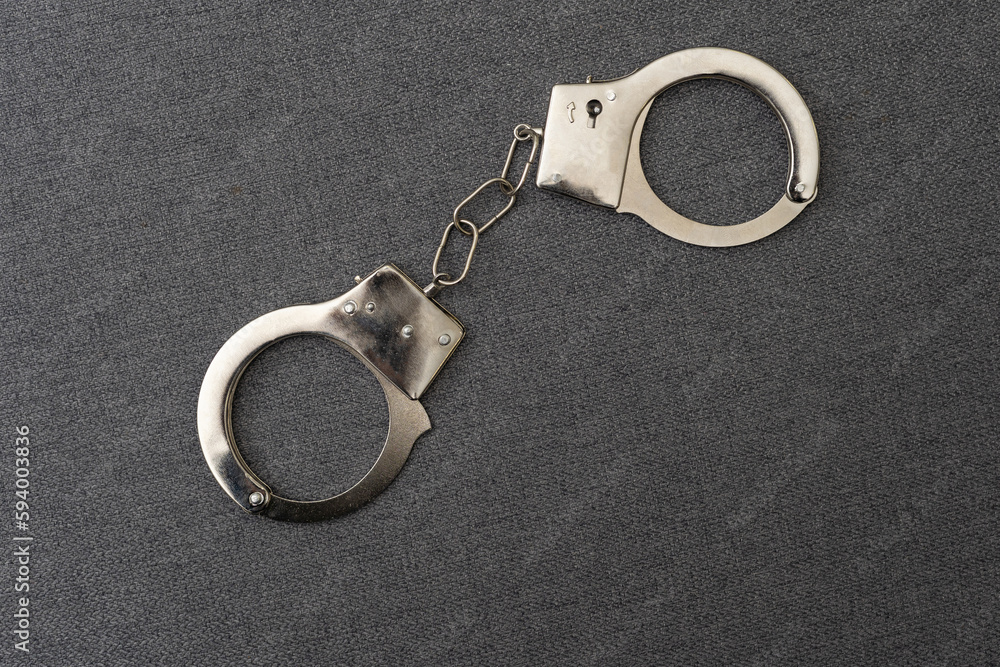 Police handcuffs on the USA flag, close-up Police handcuffs on the USA flag, close-up
