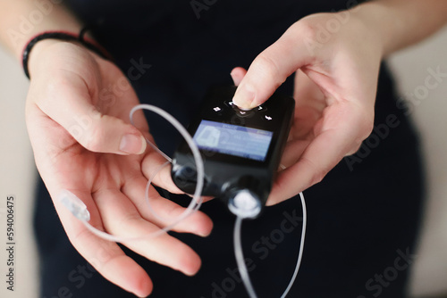 Woman holding her insulin pump in hands