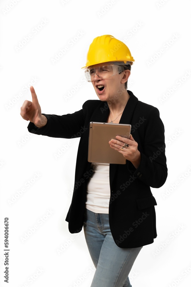Engineer woman angrily holding a tablet on white background Engineer woman angrily holding a tablet on white background