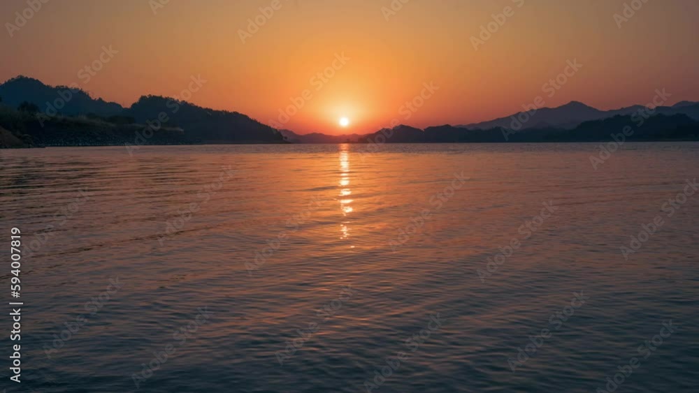 Time-lapse view of a wavy lake during a sunset