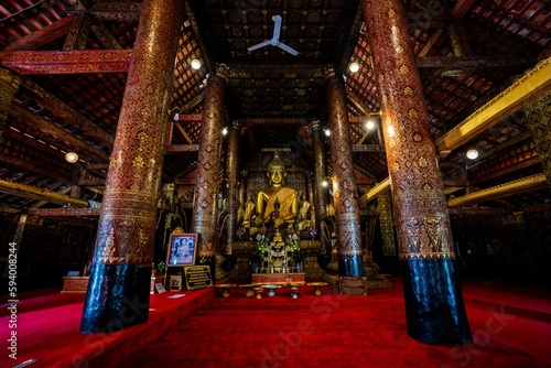 Buddha Statue inside 16th Century Buddhist Temple, Wat Xieng Thong in Luang Prabang, Laos, SE Asia