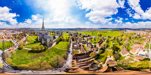 Aerial 360 VR panorama of Salisbury Cathedral and surroundings under a sunny blue sky	 photo